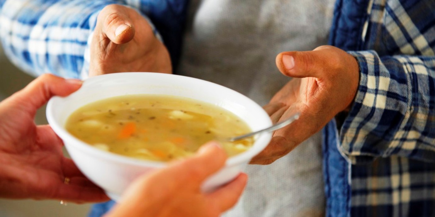 Hands of Homeless Man Receiving Bowl of Soup --- Image by © Royalty-Free/Corbis
